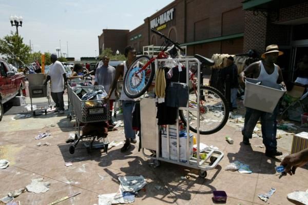 Hundreds of people loot the Super Walmart in the Garden district in southwest New Orleans after Hurricane Katrina hit the New Orleans area Monday cutting off power to the area putting a strain on the police force