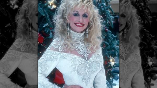 Dolly Parton in front of a Christmas tree