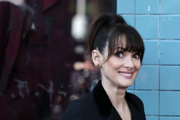 Winona Ryder smiling at the camera during Tim Burton's Hollywood Walk of Fame Star ceremony in Hollywood, California.